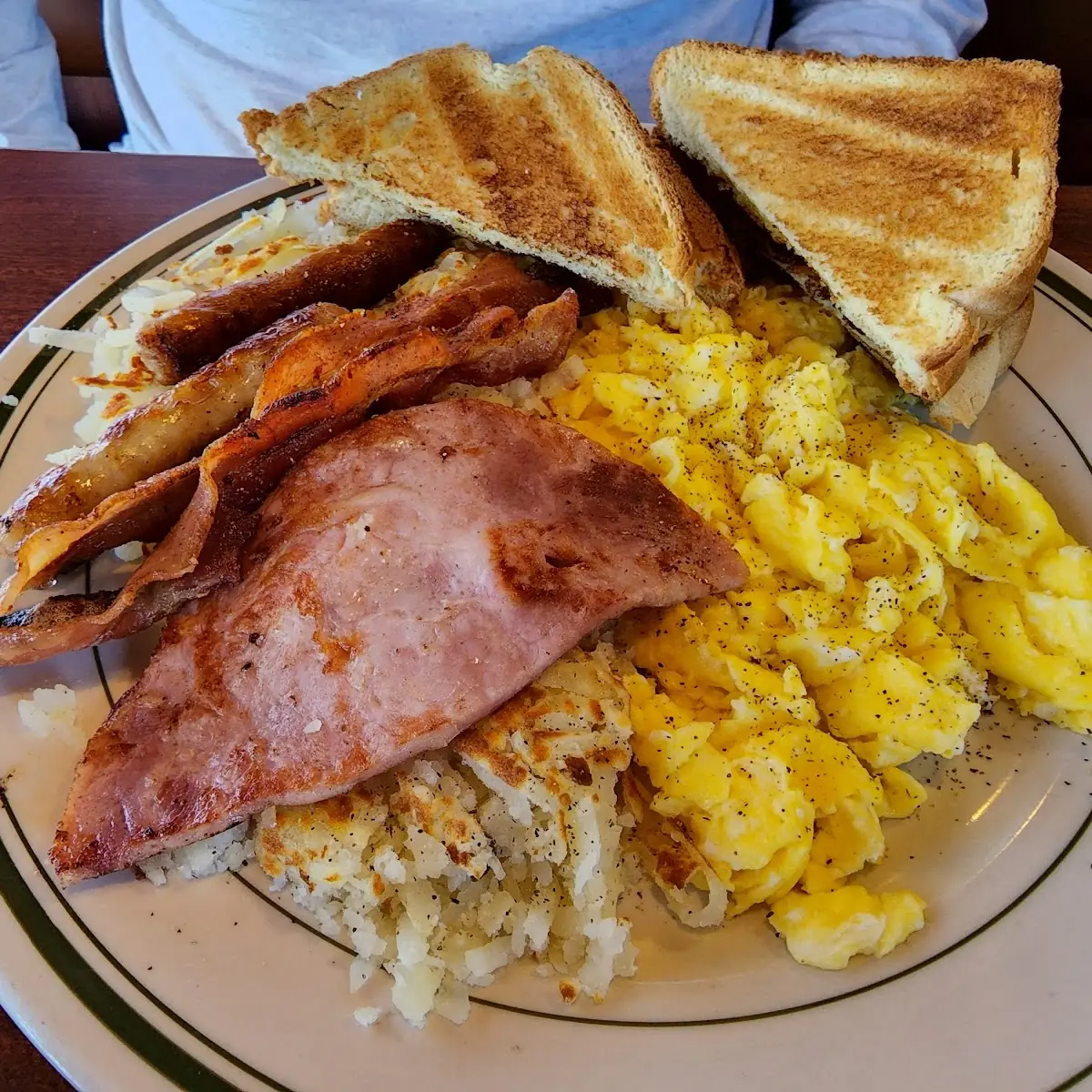 Scrambled Eggs All Meats Hash Browns and Toast