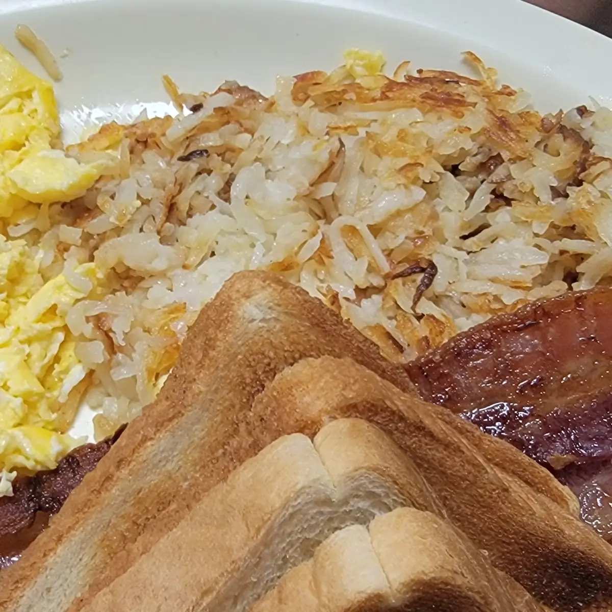 Bacon Overeasy Eggs Hash Browns and Toast