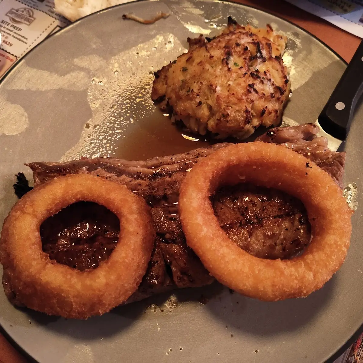 New York Strip Steak with Onion Rings and a Crabcake