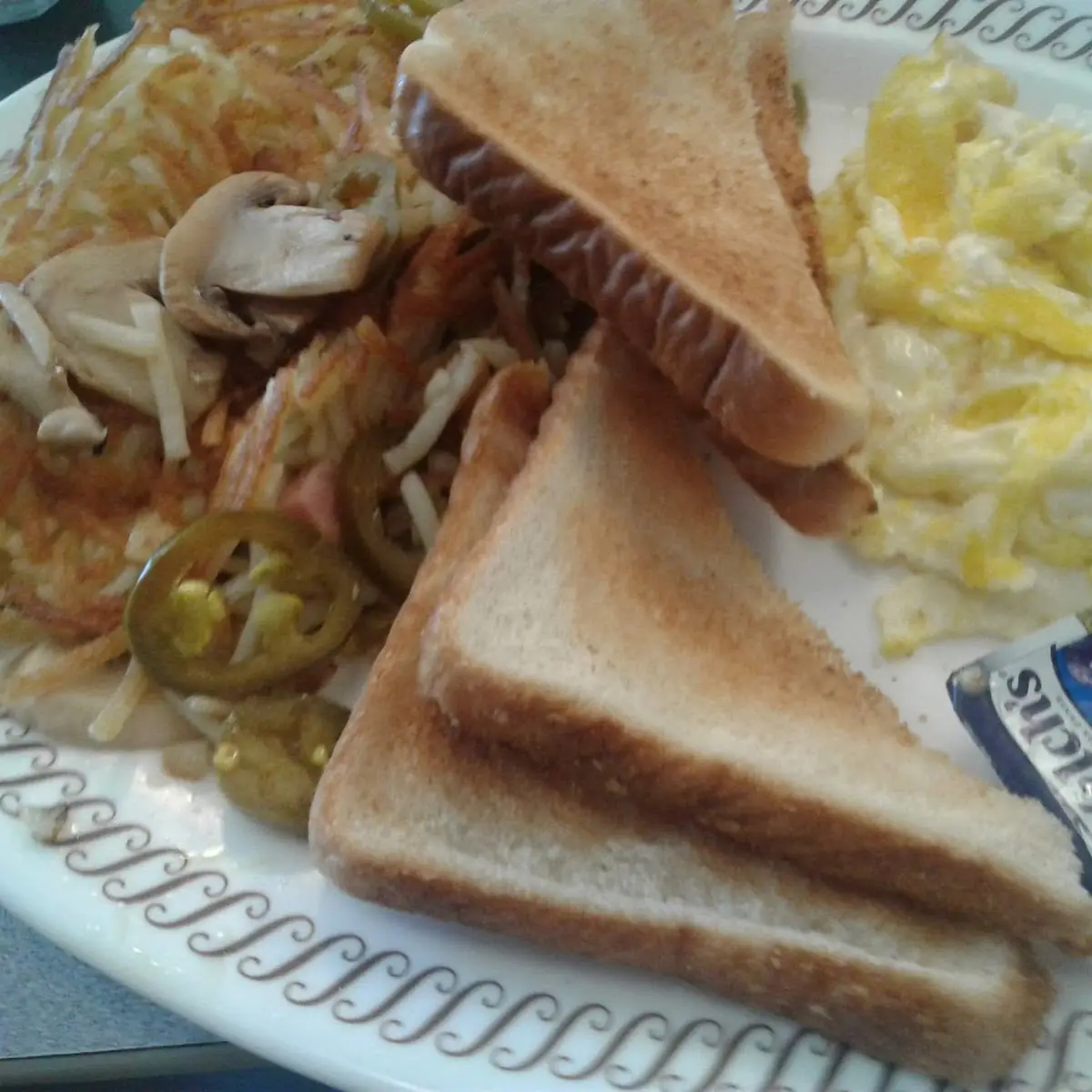 Scrambled Eggs with Cheese Hash Browns with Jalapenos &Mushrooms and Toast