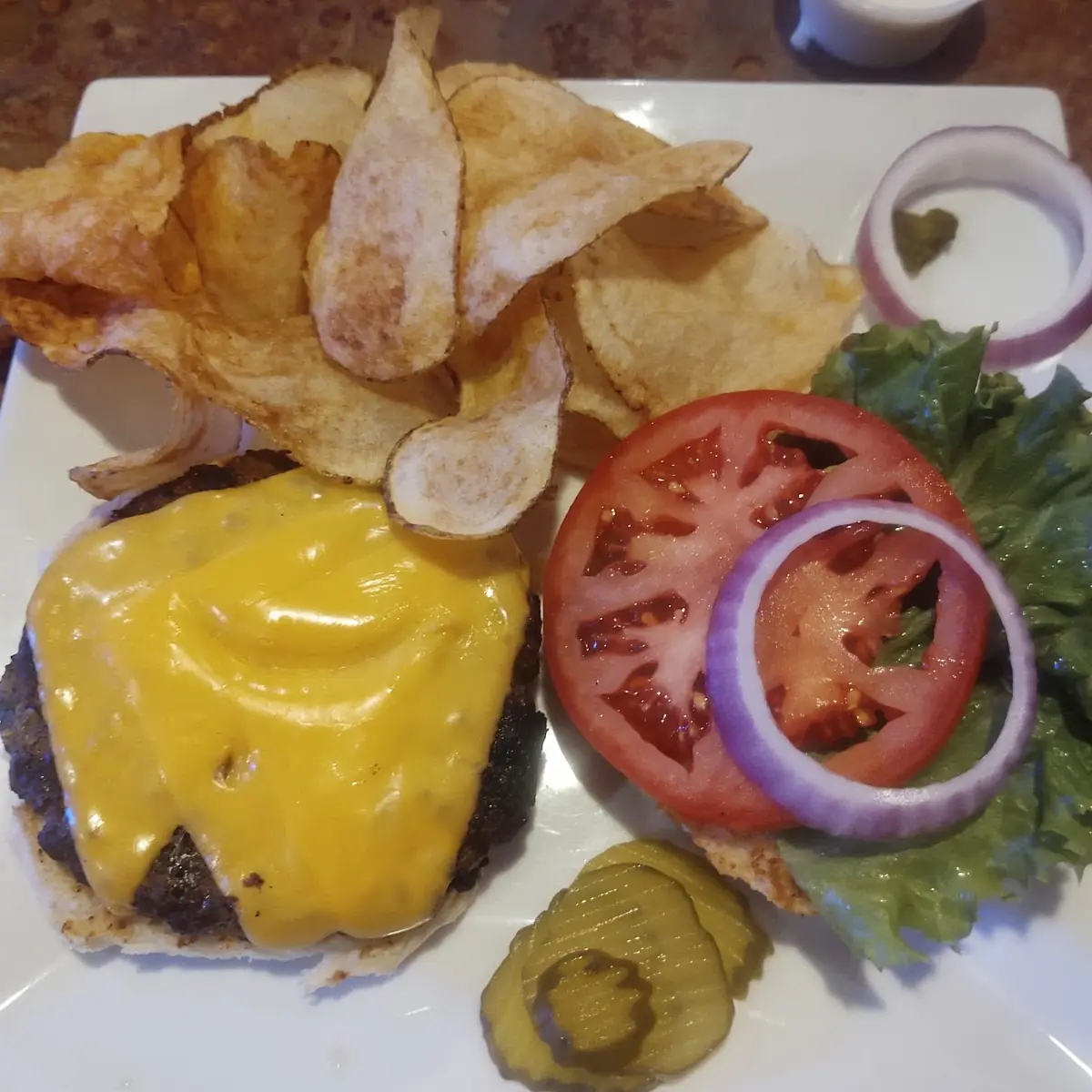 Pork Chops Okra Mashed Potatoes Cheese Burger and Chips