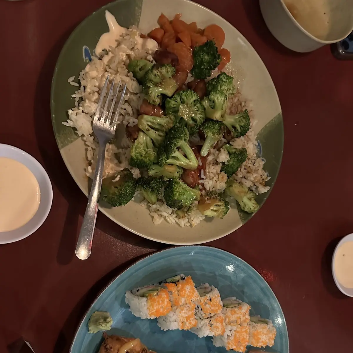Sushi Rolls and Chicken Fried Rice with Broccoli