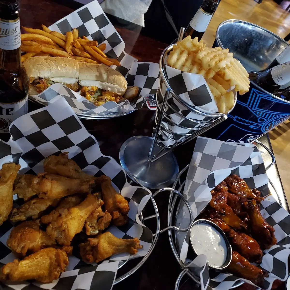 Chicken Bacon Ranch Sandwich Two Different Flavored Wings Waffle Fries and a Bucket of Beer