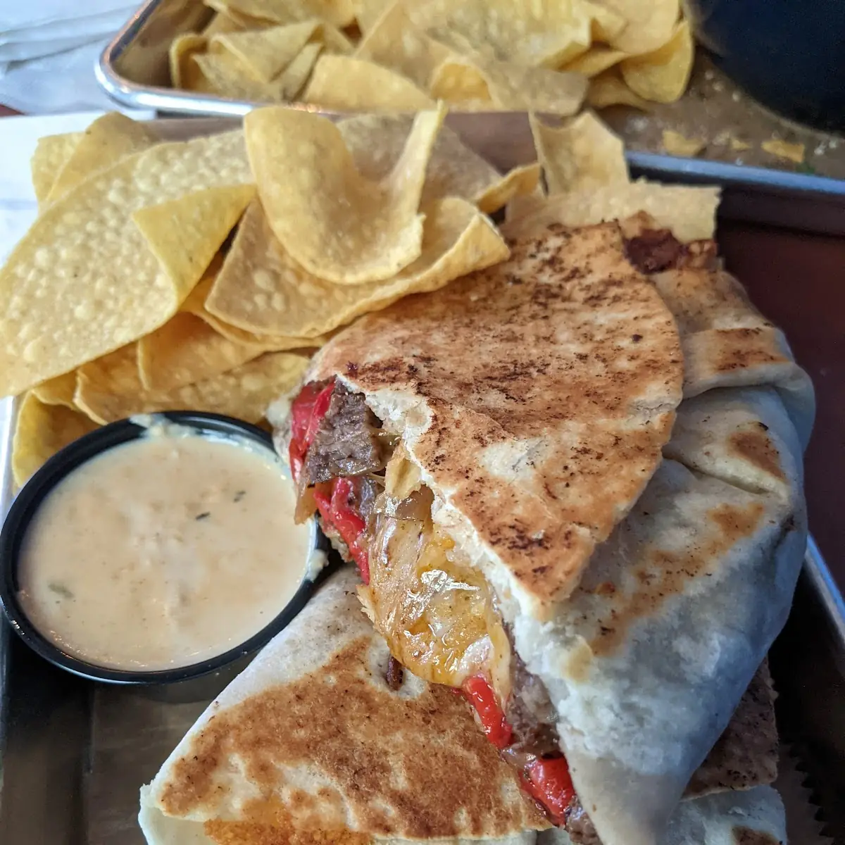 Philly Cheesesteak Burrito with Queso Dip and Chips