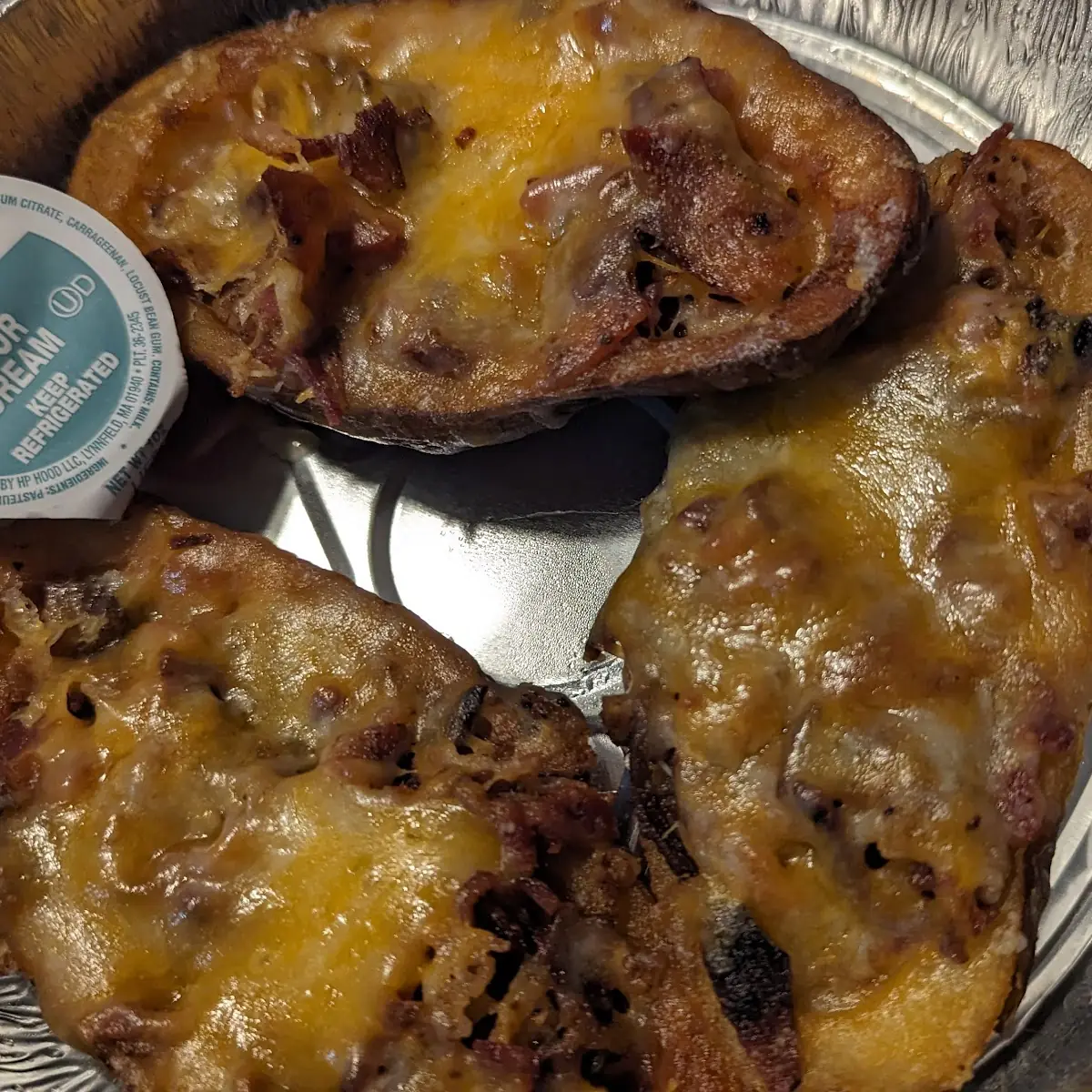 Potato Skins with Bacon and Meted Cheddar Cheese Served with Sour Cream
