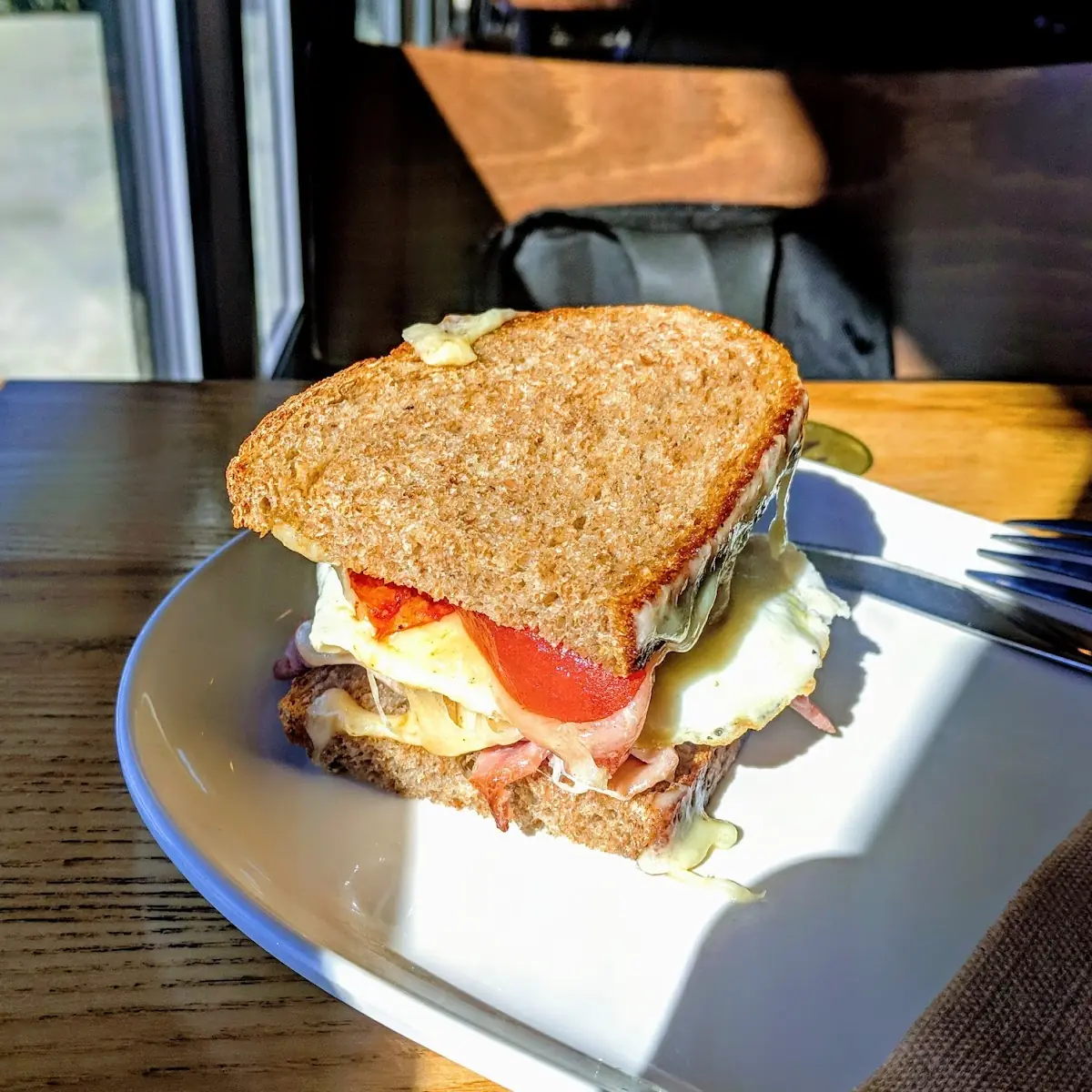 Ham Egg Cheese and Roasted Tomato Breakfast Sandwich