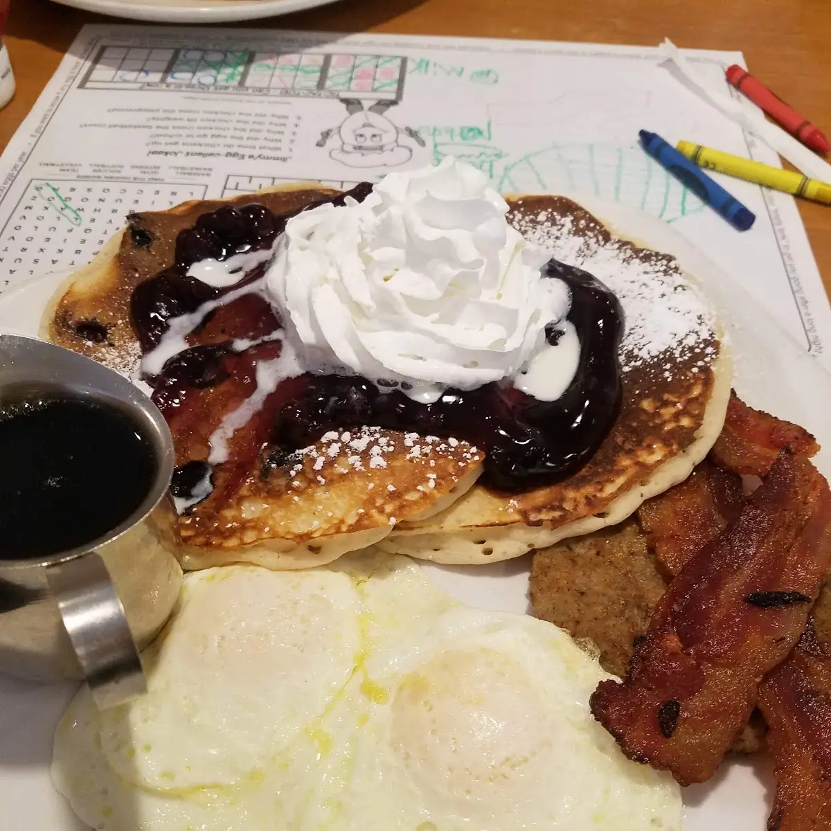 Griddle Combo with Blueberry Pancakes Fried Eggs and Bacon