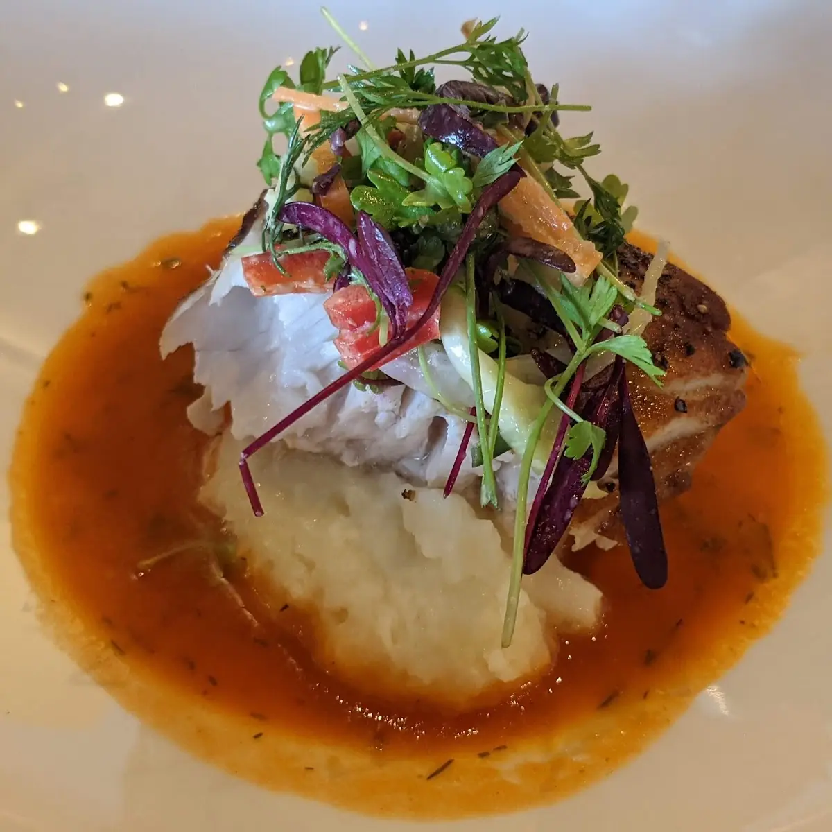 Split Portion Sea Bass Yukon Smashed with Tomato Broth