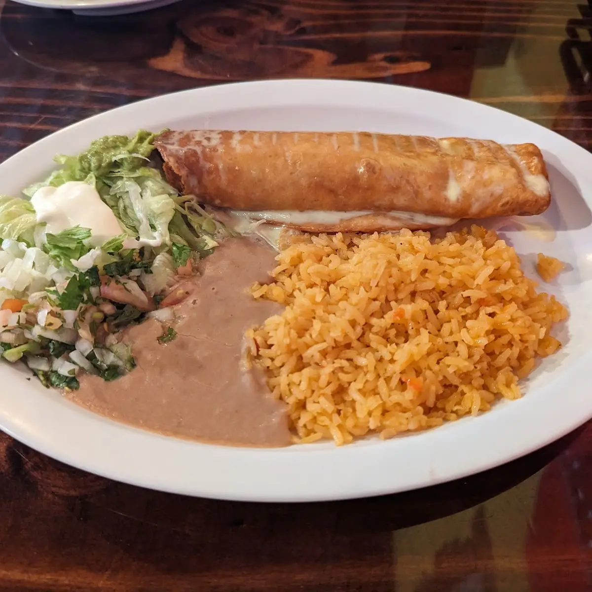 Chimichanga El Sol with Meat Deep-Fried & Covered with Cheese