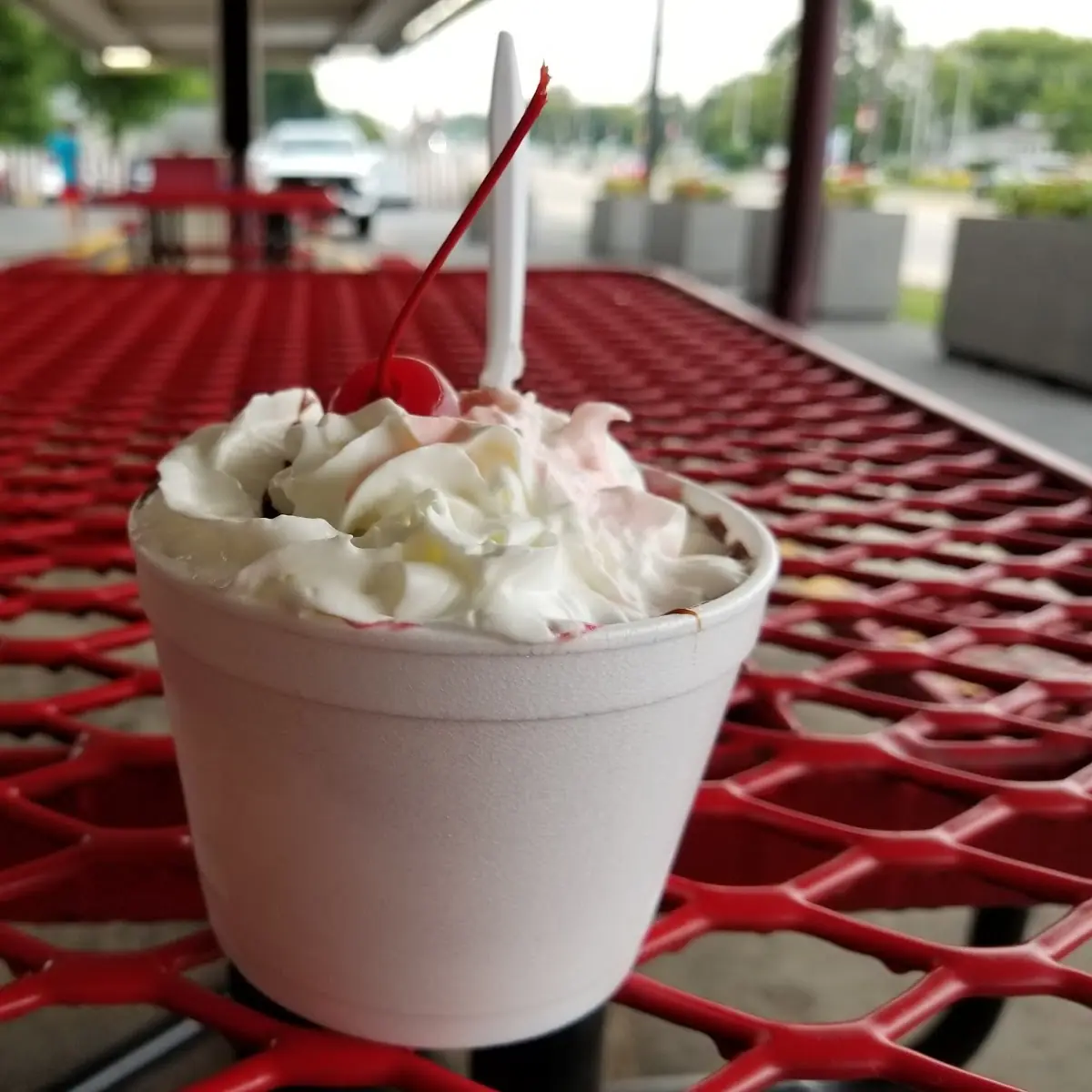 Medium Hot Fudge Sundae with Added Raspberry Sauce Whipped Cream and a Cherry