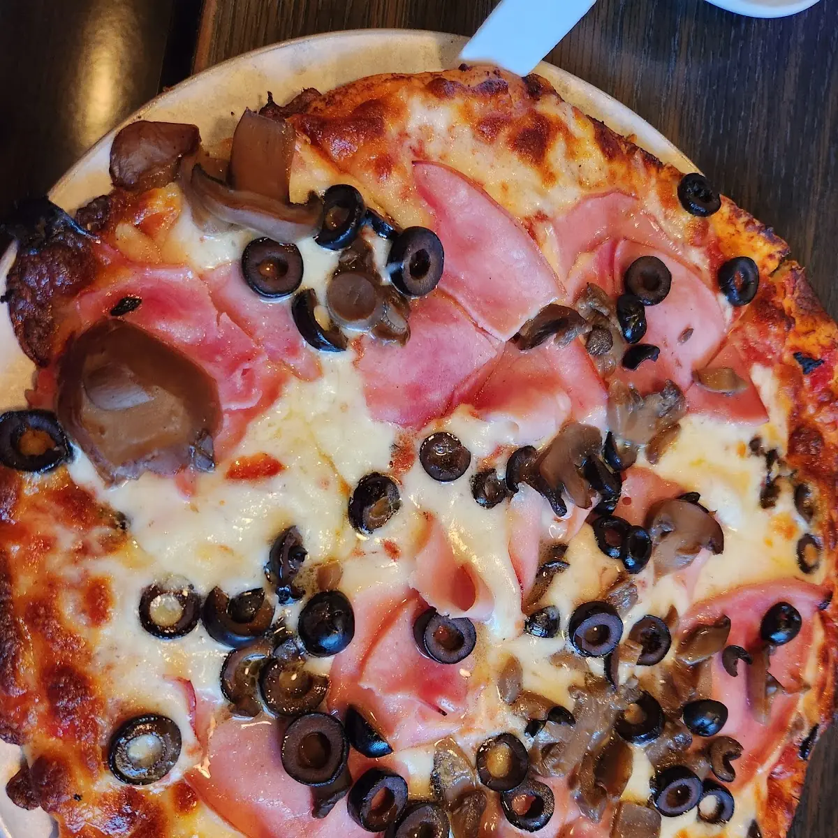 Thin Crust Ham Mushroom and Black Olive Pizza