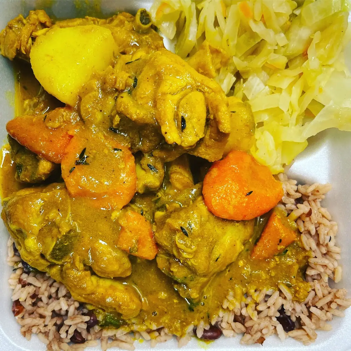 Curry Goat with Rice & Beans and Cabbage