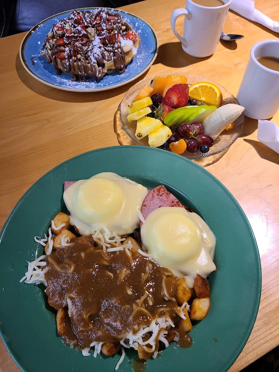 Eggs Benedict Poutine Style Home Fries Fruit Plate Strawberry Nutella Waffle