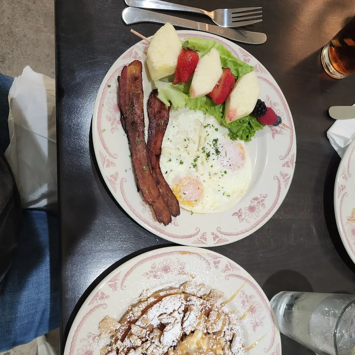 Eggs Fruit Crispy Bacon and a Pecan Waffle with Caramel Drizzle and Graham Crumble