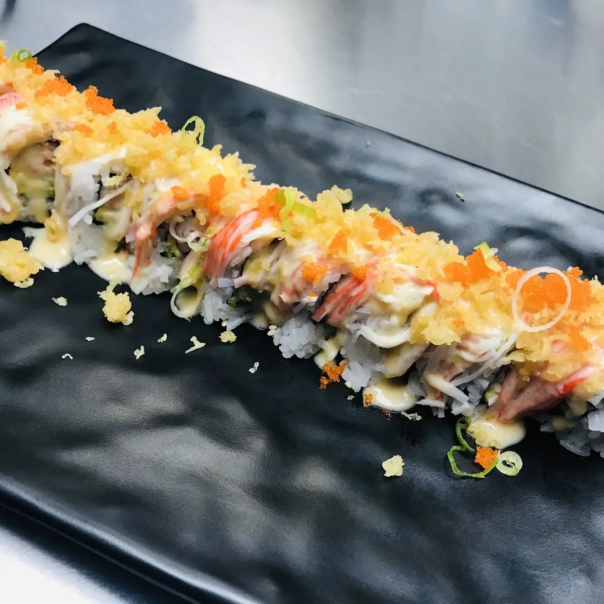 Three Different Sushi Rolls with Toppings