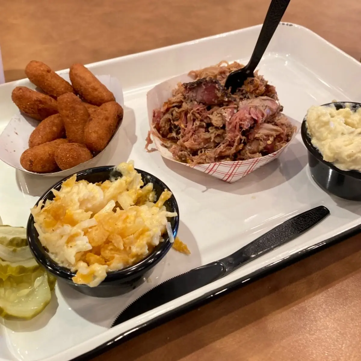 Pulled Pork Plate with Hush Puppies Deviled Egg Potato Salad and Hash Brown Casserole