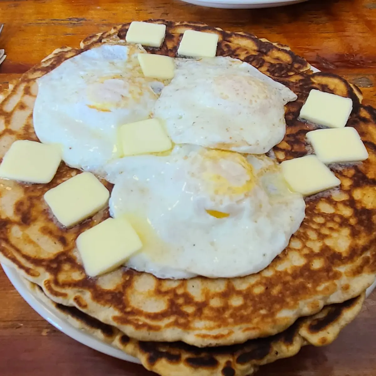 2 Cakes with over Medium Eggs on Top