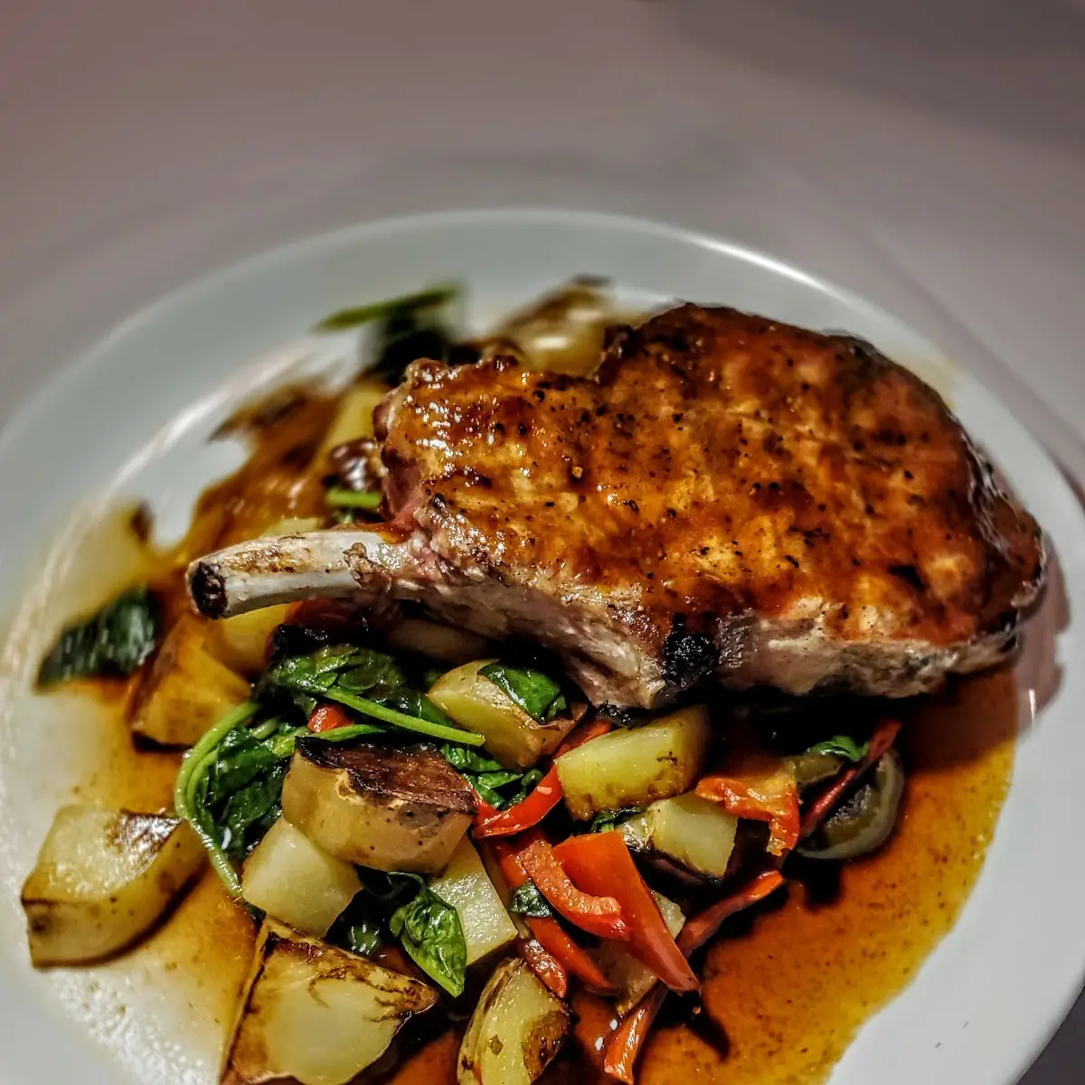 12 Oz Bone in Pork Chop Murphy Style Crispy Potato Cherry Pepper Sweet Pepper Spinach Balsamic Jus