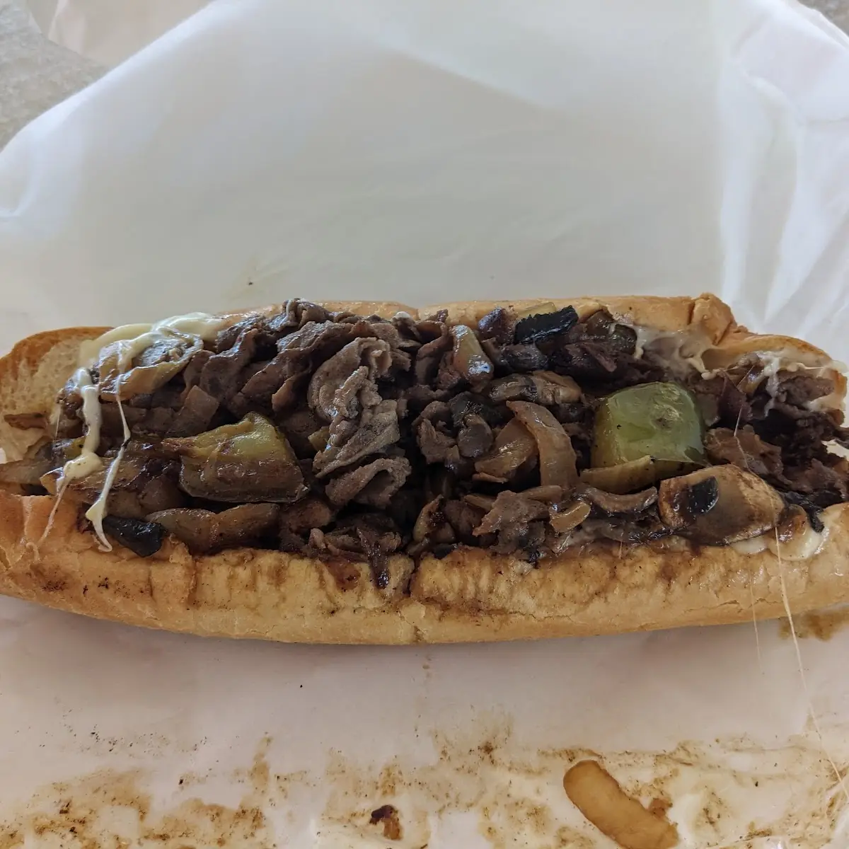 Philly Cheese Steak Sandwich with Bacon and Swiss Cheese