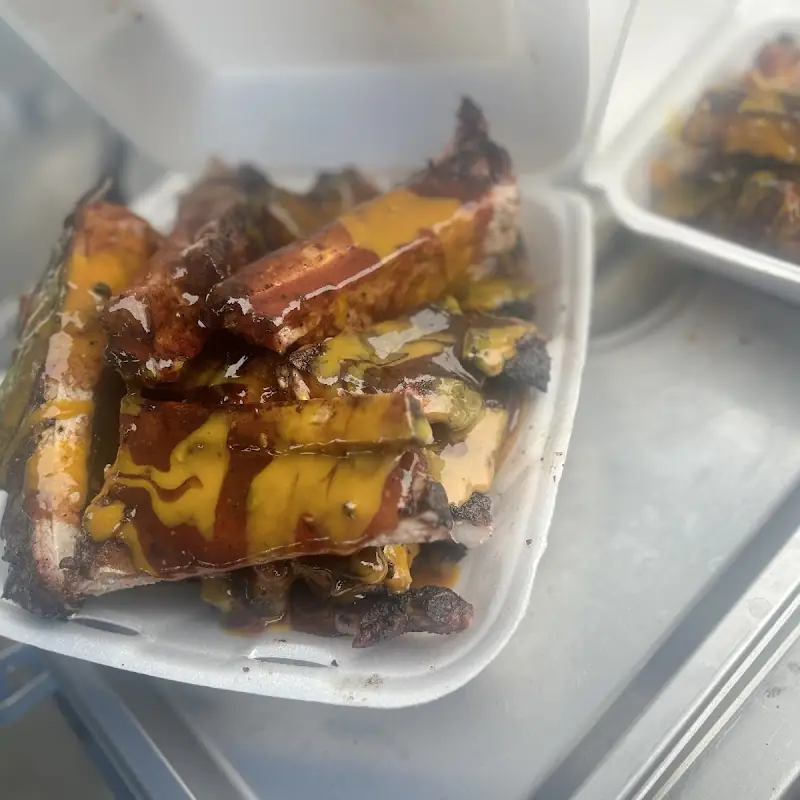 Oxtails slow cooked seasoned to perfection served with Rice&peas steam cabbage