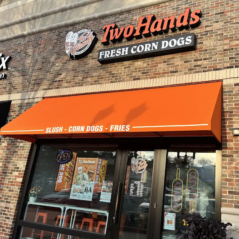 Two hands corn dogs